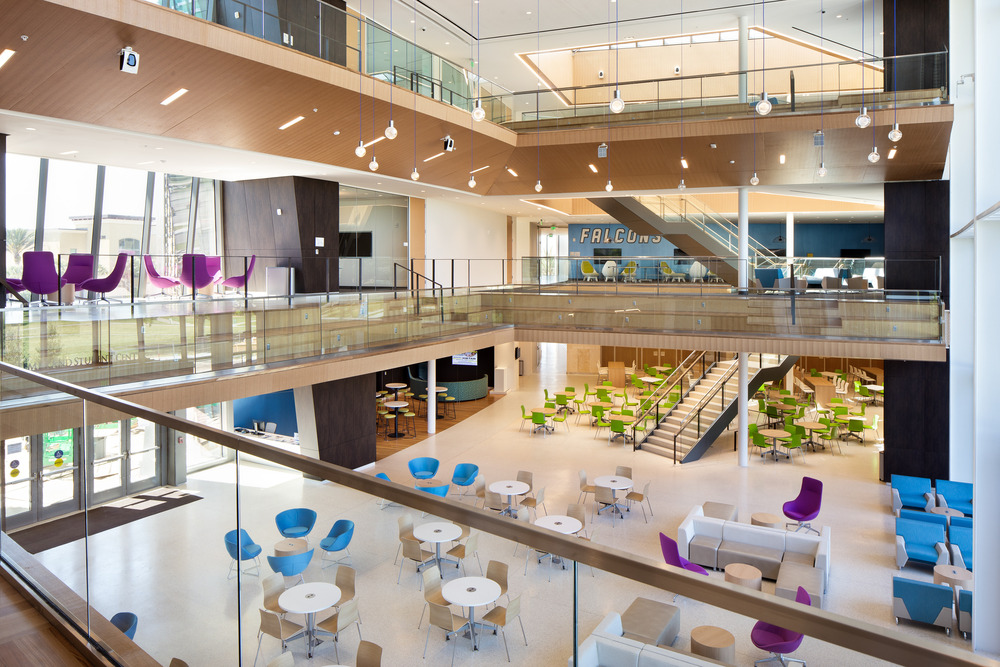 Multi-level student commons with cantilevered amphitheater seating.