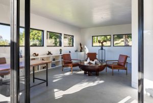 The white plaster office space and library.