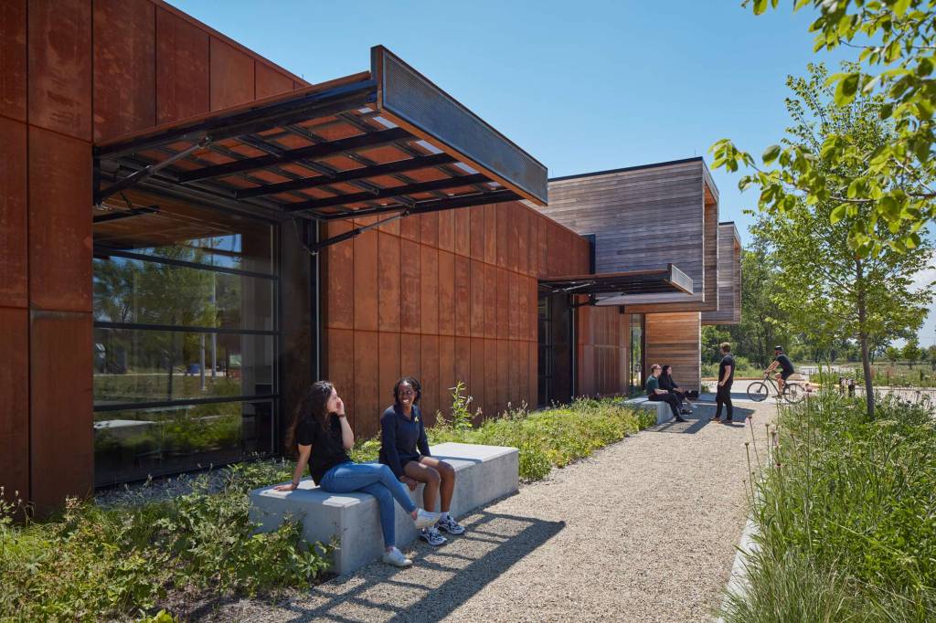 During the day, the weathered steel gates over the windows are open and provide shade and remove any reflections on the glass windows for a bird-friendly design.