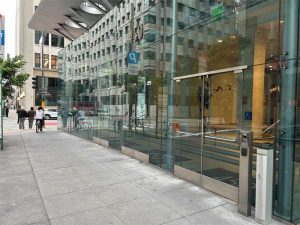 Mostly all-glass facade with a floor door operator. 