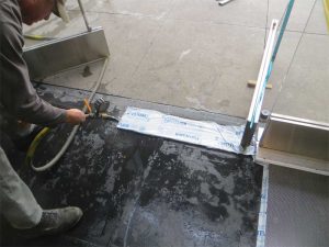 Watertesting of leaking floor door closer in progress.