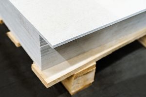 Close-up of a stack of gypsum boards on a wooden pallet. 