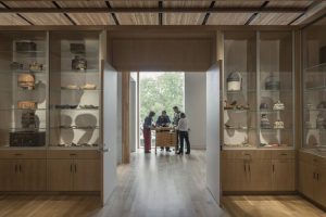 A wooden display area showcases Norwegian artifacts and collectibles.