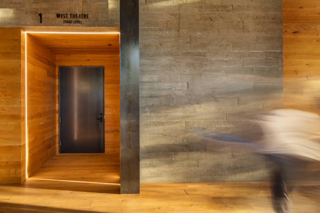 A board-formed concrete wall in the interior coupled with wood finishes.