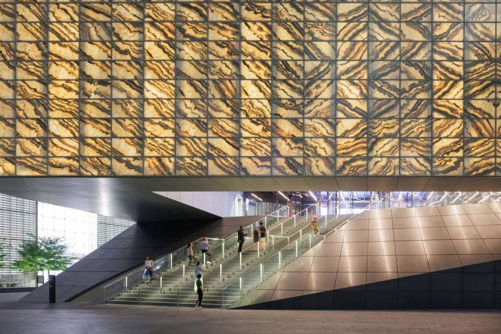 The lit-up entrance lobby can be seen at the opening to the cube by passersby and visitors.