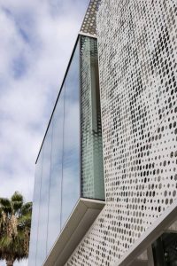 The detail of the scrim shows three sizes of hexagonal perforations.