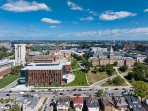 The photo shows the terracotta and glass materials achieve integration with the architecture of the rest of the campus buildings.