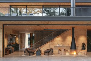 The interior is a blend of sophisticated contemporary lines with rugged materials, using a primal palette of regional pine, concrete, steel, and glass.