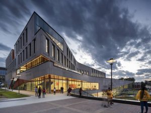 The sweeping curves of the north facade culminate at prow-like corners that stretch towards the historic campus precinct. The third-floor terrace cantilevers above the exterior stairway, its prismatic metal soffit guiding students around the corner towards the second-level entrance.