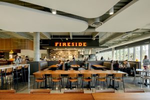 Students shown getting the food from one of the eateries in the center, Fireside, and sitting at the seating area by the eatery.