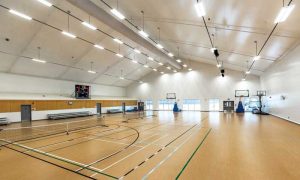 An indoor basketball court facility is built using tension fabric, which creates a bright indoor environment.