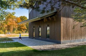 The building has a covered porch extending its length.