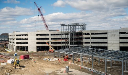 Construction site with cranes and a partially built structure.