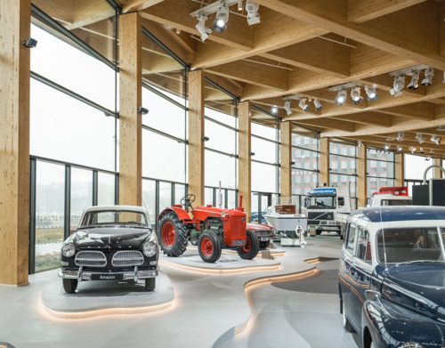 cars displayed in a wood-clad showroom