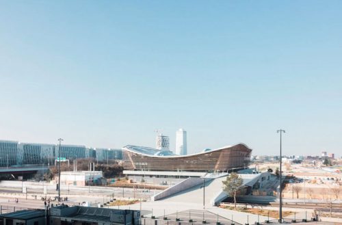 exterior shot of an aquatics centre with a wooden roof