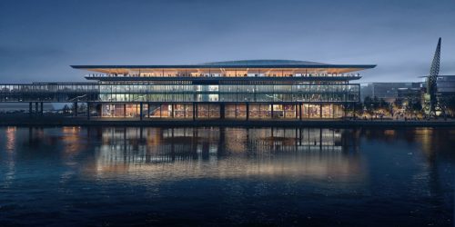 a well lit ferry terminal at night with a waterfront