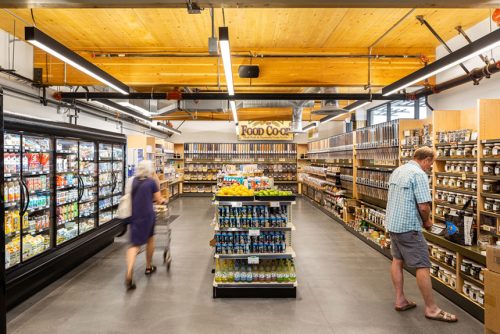 rendering of a food aisle that is well-lit and shoppers looking at products