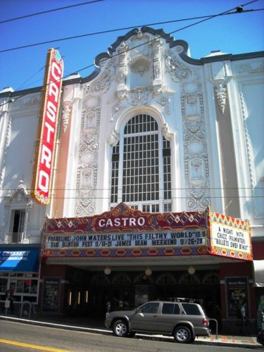 historic Castro theatre exterior in white with a jeep parked in front of it