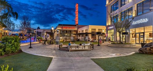 empty plaza at nighttime with stores