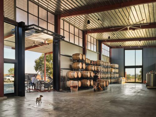 inside view of a winery with stocked barrels