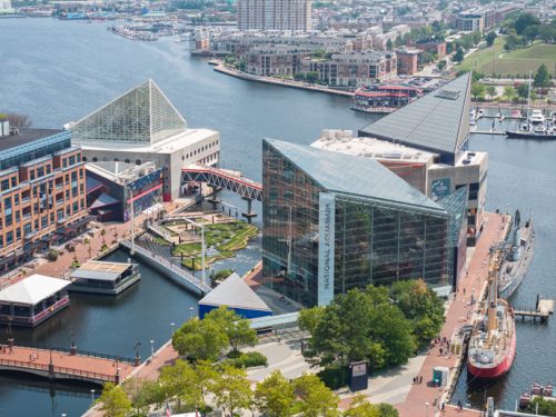 aerial view of a harbour with a glass-clad building