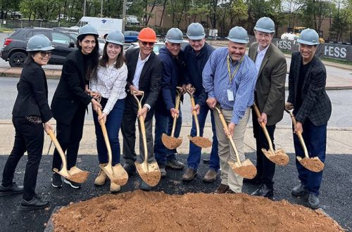 group of people with construction hats and shovels