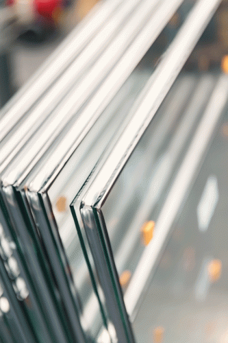 Close-up of stacked glass panels with double-layered construction and clean, polished edges, showcasing high-quality craftsmanship in glass manufacturing.